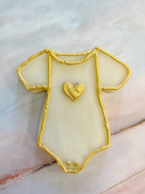 how to decorate gold and white baby shower cookies onesie cookie