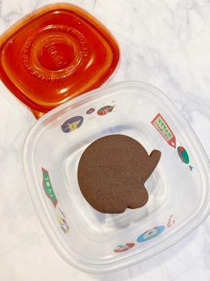chocolate cut out cookies stacked in an airtight container