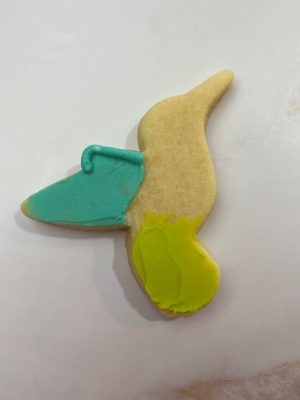 Draw the top & side of the upper hummingbird wing with buttercream.