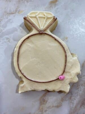 piping a rose bud onto the cookie
