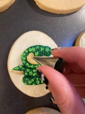 snake sugar cookies with buttercream using the tip 5 to create the snake scales with a piping tip